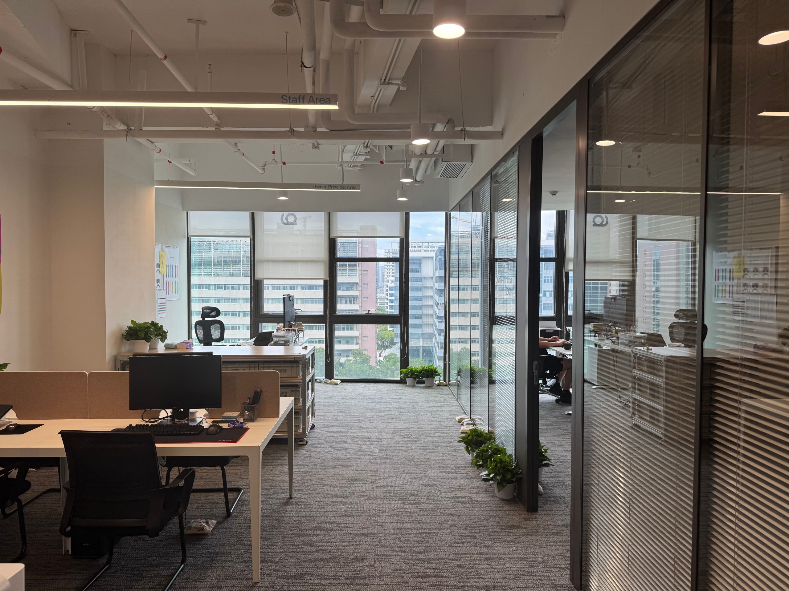 Home Bright, modern office interior with large windows and open workspace design.